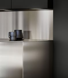 a stainless steel cabinet with two cups on it