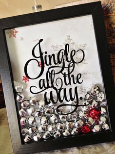 some red and silver items are in a black frame with the words jingle all the way on it