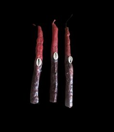 three pieces of meat on a black background