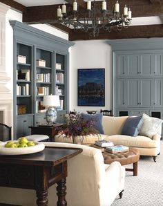 a living room filled with furniture and a chandelier