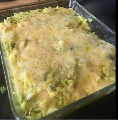 a casserole dish with broccoli and cheese in it on a table