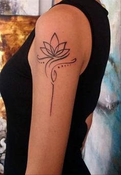 a woman's arm with a tattoo on it that has a flower in the middle