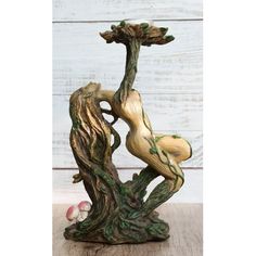 a figurine sitting on top of a tree trunk