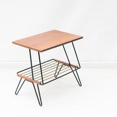 a small wooden table sitting on top of a metal rack