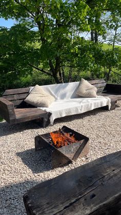 an outdoor seating area with fire pit and benches