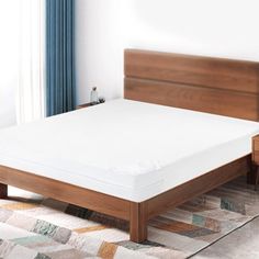 a bed with a wooden headboard and foot board next to a window in a bedroom