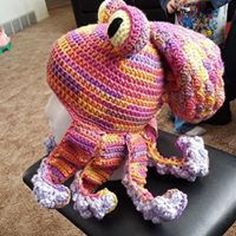 a crocheted stuffed animal sitting on top of a chair