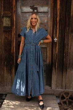 Effortlessly stylish and versatile, the Blue Ridge Denim Maxi Dress is your new go-to piece. It’s all about laid-back bohemian charm with a touch of chic that will transition perfectly from season to season! High-quality solid denim fabric Relaxed and loose silhouette at a maxi length Classic collared neckline with a button-up front closure Short sleeves with cute banded cuffs Flattering self-tie belt and tiers throughout for added boho style Pair with: High Neck Racerback Brami, Great Plains Az Plus Size Denim Dress Outfit, Chambray Dress Outfit Winter, Denim Dress Layering, Denim Maxi Dress Outfit, Long Denim Dress Outfit, Denim Bridesmaid Dresses, Vintage Style Dresses Casual, Chambray Dress Outfit, Family Photo Dress