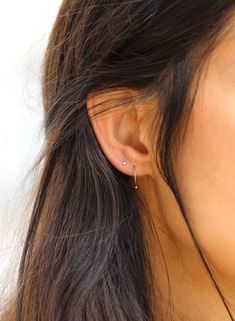 a close up of a person wearing a pair of ear piercings