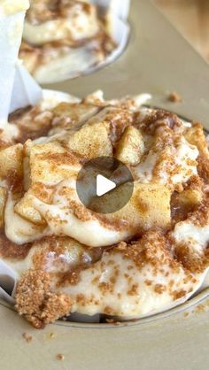 two desserts sitting on top of a metal pan covered in icing and cinnamon