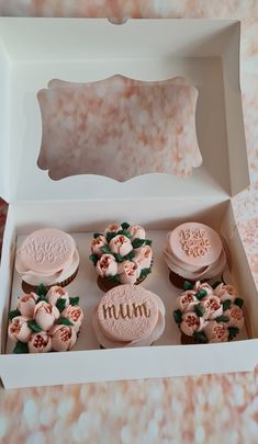 the cupcakes are decorated in pink and white icing with flowers on them