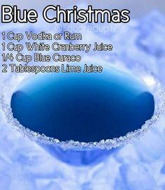 the blue christmas cocktail is served in a martini glass with ice on top and below it