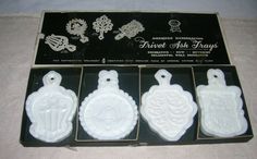 four white ceramic tags in a box on a table