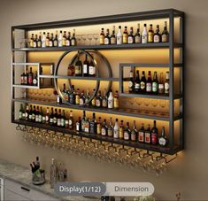 a wall mounted wine rack filled with lots of bottles and glasses next to a bar