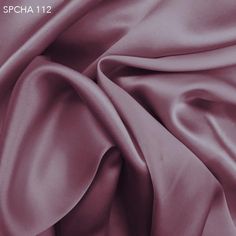 a close up view of a purple satin fabric with the word, spha 121