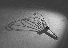 a black and white photo of a whisk