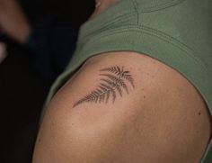 a woman with a fern tattoo on her shoulder