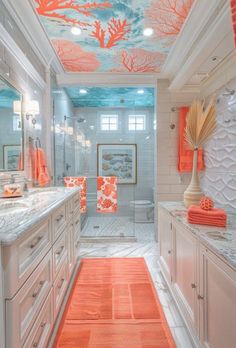 an orange and white bathroom with coral accents