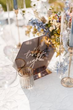 a close up of a table with flowers and candles