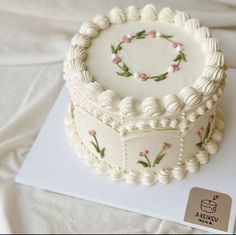 a decorated cake sitting on top of a white sheet