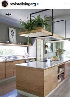 a kitchen filled with lots of wooden cabinets and counter top space next to a window