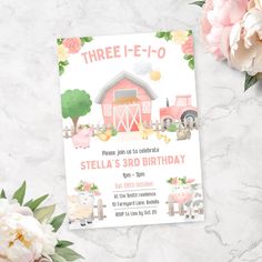 there is a birthday card with farm animals and flowers on the table next to it