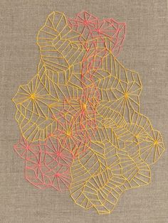 an embroidered piece with yellow and red lines on it's sides, in the shape of leaves