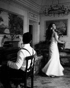 a man and woman in formal wear standing next to each other near a piano player