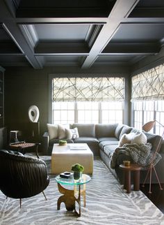 a living room filled with furniture and lots of windows