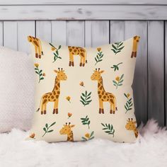 a pillow with giraffes and leaves on it