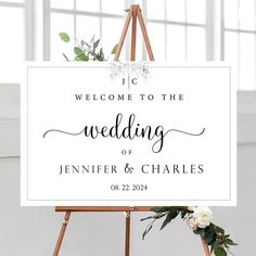 an easel with a sign that says welcome to the wedding of jennifer and charles