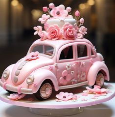 a pink car with flowers on top is sitting on a cake plate in the shape of a flower