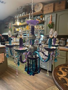 a chandelier hanging from the ceiling in a kitchen