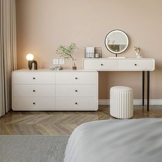 a bedroom with a white dresser and mirror