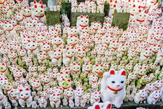 there are many stuffed animals on display in the store together, and one is white with red spots