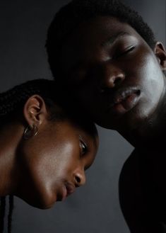 two people are posing for the camera with their heads close to each other, one has his eyes closed