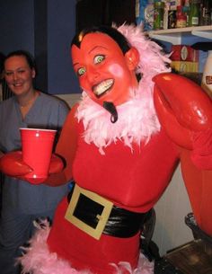 a man dressed as santa clause holding a red cup