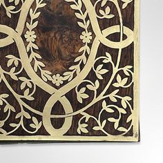 an intricately carved wooden panel with vines and leaves