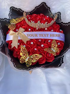 red roses in a black heart shaped box with gold butterflies and pearls on the side