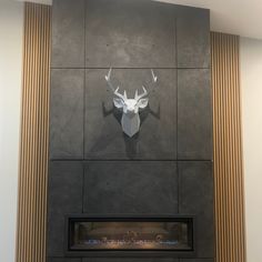 a fireplace with a deer head mounted on the wall