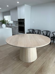 a large wooden table sitting in the middle of a kitchen