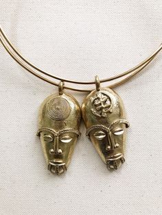 "A stunning 2.5\" bronze African Mask hand crafted in Ghana on a thick handmade brass choker. These mask features a detailed crown, perfect eyebrows and distinct facial features. Mask Size: 2.5\"L x 1.5\"W Choker length: 16\" Unisex *Ships with a polishing cloth to keep it forever shining. *Packaged for gift giving. *Sold individually. Return to shop: Afrohemien.etsy.com Like and Follow Afrohemien for updates, sales, coupons and surprise giveaways Instagram/Blog: instagram.com/Afrohemien Tumblr: Afrocentric Jewelry, Yeezy Fashion, African Skirts, African Accessories, Mask Necklace, African Mask, African Necklace, Wrist Jewelry, Perfect Eyebrows