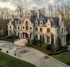 this is an aerial view of a large mansion in the middle of a wooded area