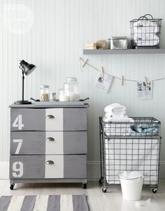 an image of a dresser with drawers and baskets on the top, next to other items