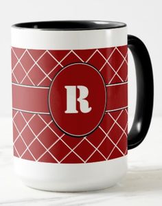 a red and white coffee mug with a monogrammed r in the middle on it