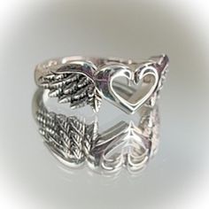 Beautiful Sterling Silver Heart With Wings Ring Available In Sizes 6, 8, 9 Top Of Ring Height: 8.6mm Band Width: 2.7mm Shank Width: 2.5mm Metal: 925 Sterling Silver Plating: Rhodium Plated Finish: High Polish Wlw Promise Rings, Gothic Sterling Silver Promise Jewelry, Cheap Silver Gothic Rings, Cool Silver Rings, Darry Ring, Silver Gothic Jewelry With Heart Charm, Vintage Silver Heart-cut Rings, Vintage Sterling Silver Heart Ring, Grunge Rings