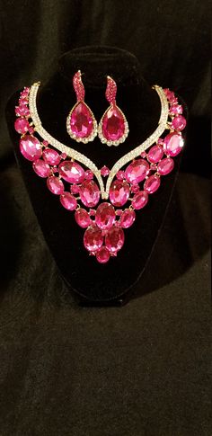 Bib necklace and dangle earring set.  Embellished in rose pink gems and rhinestones. Earrings are an elegant teardrop design in gold times finish and adorned with lab created rhinestones and rose pink stones. Pink Stones, Pink Gem, Bib Necklaces, Necklace And Earring Set, Bib Necklace, Pink Stone, Rose Pink, Pink Roses, Earring Set