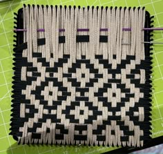 a close up of a piece of cloth on a table with scissors and sewing needles