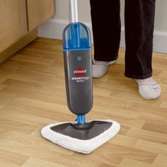 a person using a steam mop on the floor