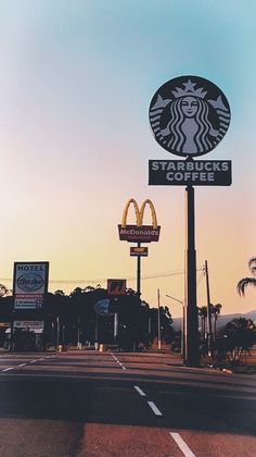 there is a sign that says starbucks's coffee on the side of the road